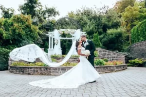 Valley Regency -Bride and groom with veil flying outdoors - MC Productions Photography