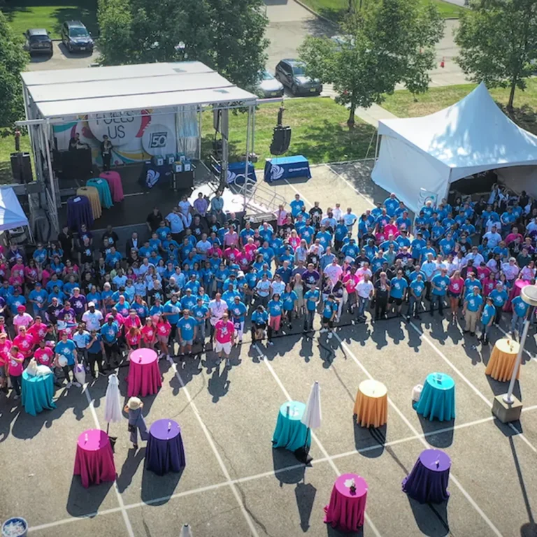 Aerial drone photo of a large corporate outdoor event with hundreds of attendees in team shirts, New Jersey