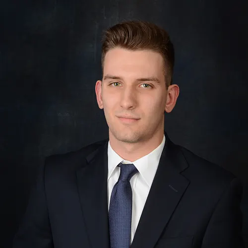 headshot photographer of a young man in black suit