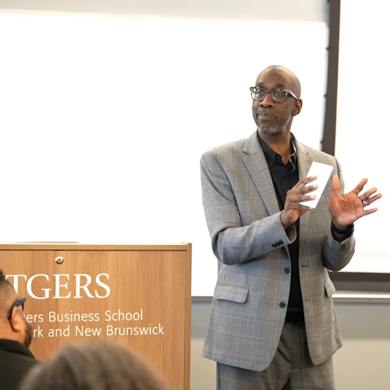 Keynote speaker presenting at a Rutgers Business School event in Newark and New Brunswick